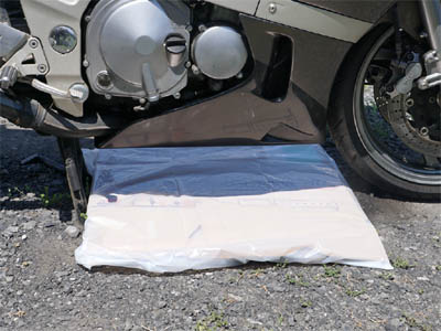 バイクのカウルを取り外す際に使用するゴミ袋で包んだ作業用のダンボール
